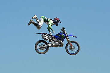 Motorcycle rider in mid-air completely off his bike