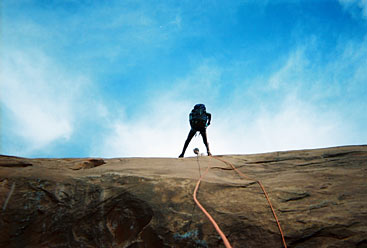 Preparing to go over the edge with rope attached
