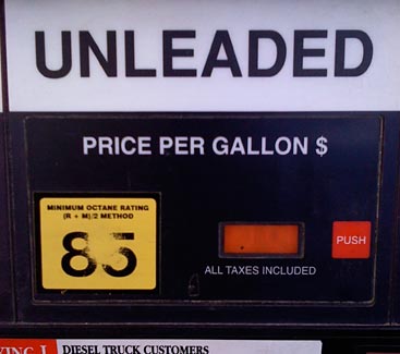 Gas pump interface showing grade sticker worn out from finger presses with smaller start button to the right